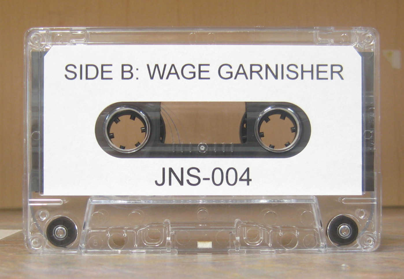 audio cassette with paper label titled Wage Garnisher