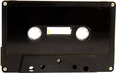 black audio cassette with yellow leader, tabs out