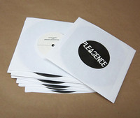 7 inch records in white paper sleeves